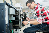 Casual man working with printing machine