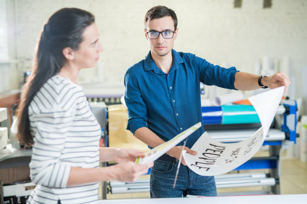 Coworkers of typography discussing placard