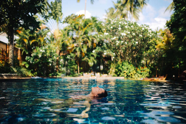 istock Young woman relaxing in the pool 1044866900