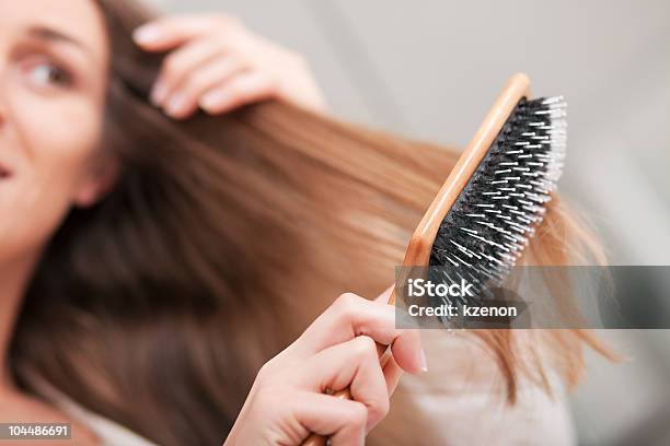 Young Woman Brushing Her Hair Stock Photo - Download Image Now - Hairbrush, Combing, Women