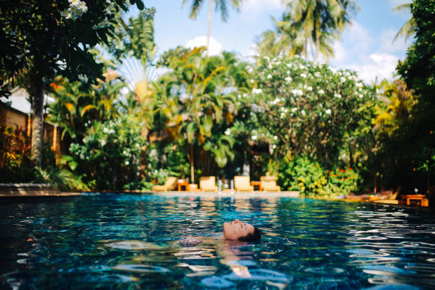 istock Young woman relaxing in the pool 1044867016