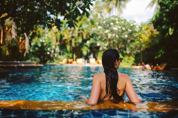 istock Young woman relaxing in the pool 1044867068