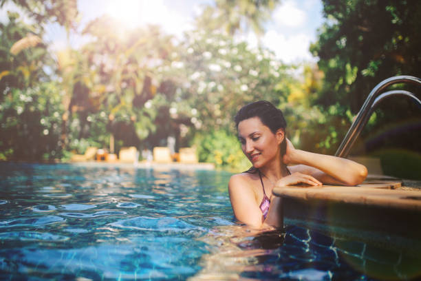 istock Young woman relaxing in the pool 1044867242