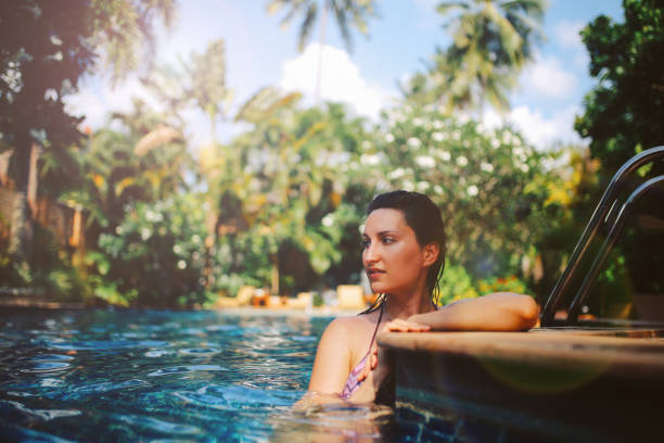 istock Young woman relaxing in the pool 1044867486