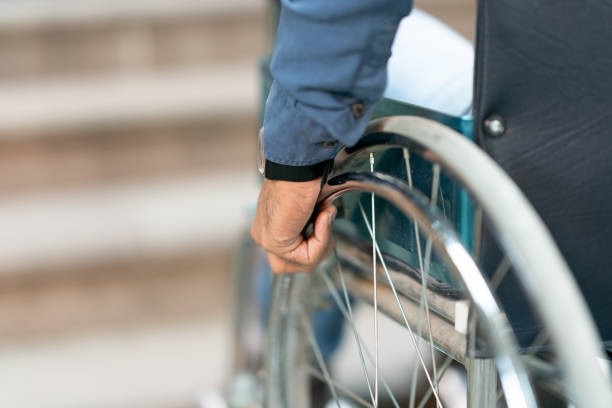 istock Disable man in front of a staircase on his Wheelchair, Boundary. 1044870532
