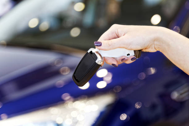 istock Womans hand holding car key 1044871422