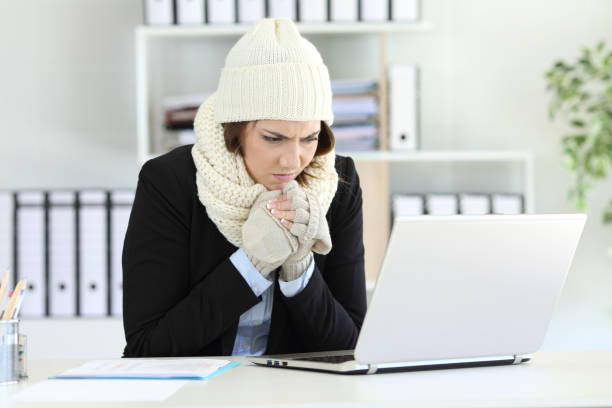 Cold executive working with a heater failure in winter stock photo