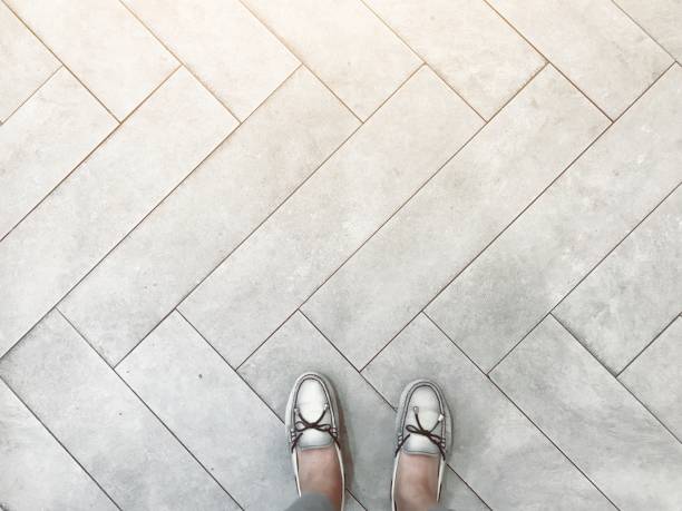istock Top view of selfie feet on pattern concrete floor background, decision making , Choices concept, where to go, directions, business solutions, uncertainty 1044875088