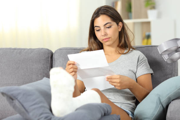 istock Relaxed disabled woman reading a letter at home 1044875284