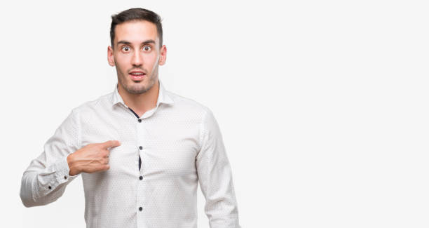 istock Handsome young business man with surprise face pointing finger to himself 1044876032
