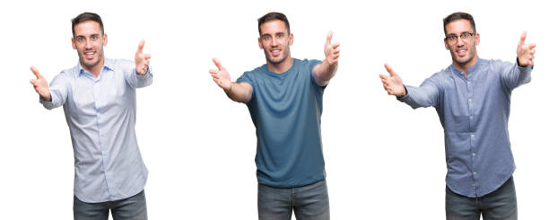 istock Handsome young man wearing different outfits looking at the camera smiling with open arms for hug. Cheerful expression embracing happiness. 1044883836