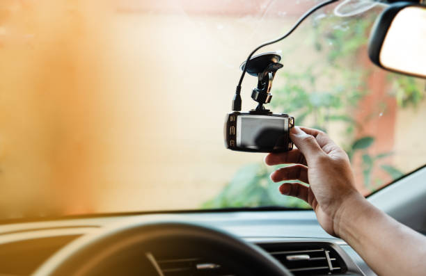 istock The human hand is touching the CCTV car camera,for check system before use,the technology for car user,for safe and secure driving,warm light tone,blurry light around 1044884196