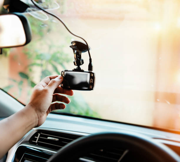 istock In selective focus of the human hand is touching car camera,before driving,for checking system of the camera recording ,the technology for car user,warm light tone,blurry light around 1044884198