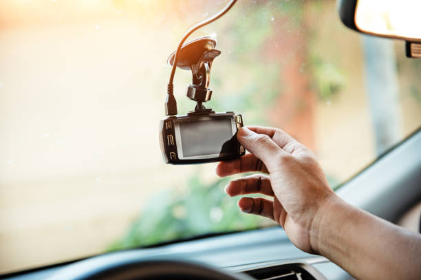 istock The human hand is touching the CCTV car camera,for check system before use,the technology for car user,for safe and secure driving,warm light tone,blurry light around 1044884200