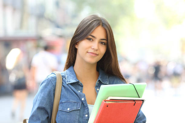 istock Relaxed student looking at camera in the street 1044887096