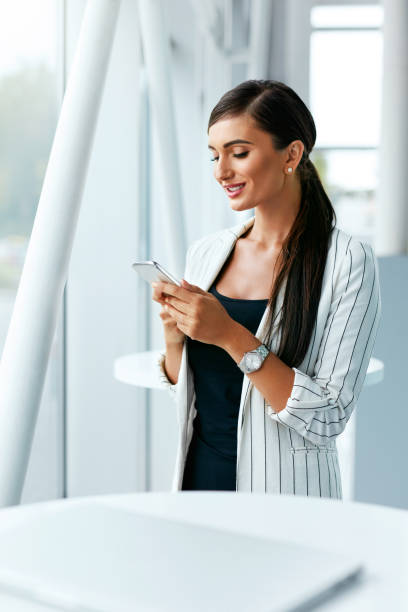istock Business Woman Using Phone Near Office 1044887276