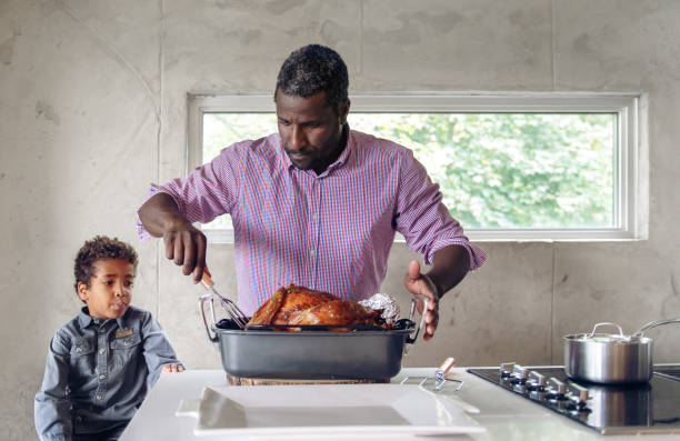 istock Fathers preparing thanksgiving turkey 1044887434