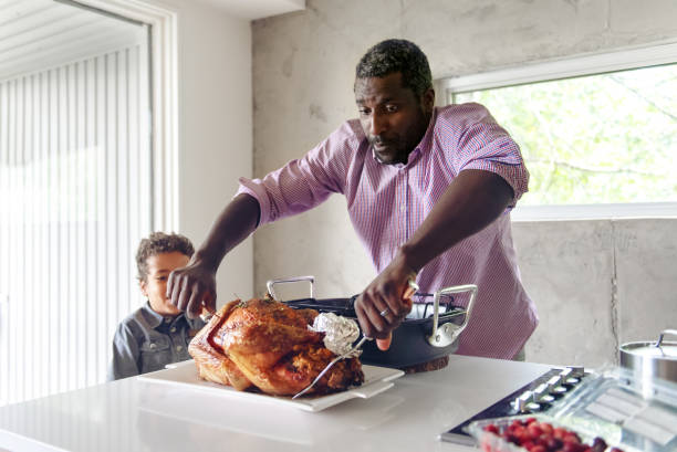 istock Fathers preparing thanksgiving turkey 1044887460