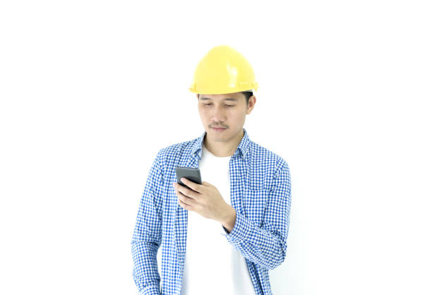 istock Business man engineer employee with blue scott shirt isolated has using phone on white background. 1044888328