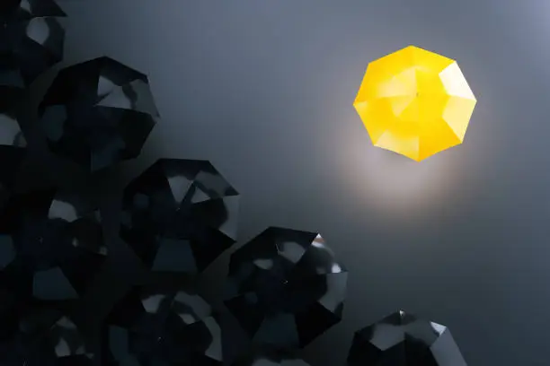 Photo of Yellow umbrella among dark ones. Uniqueness concept