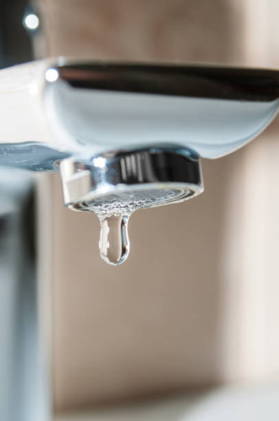 istock Tap close up and falling water drop 1044896240