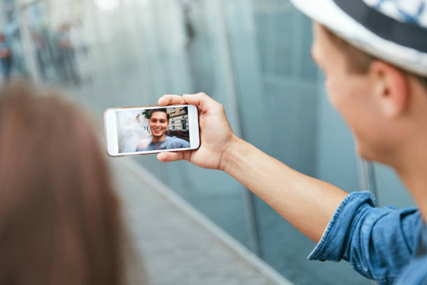 istock Video Call On Phone. Hand With Phone And Face On Screen 1044896508