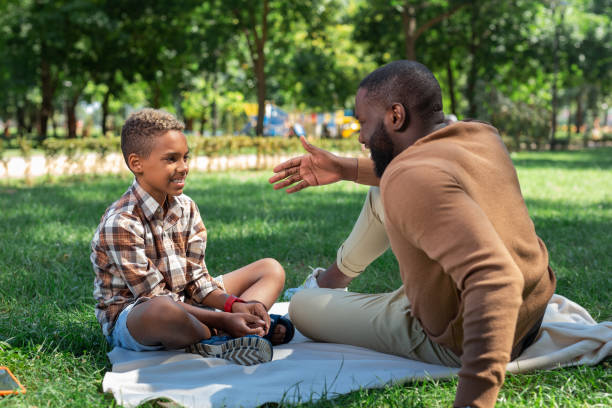 istock Delighted nice man telling a story to his son 1044900606