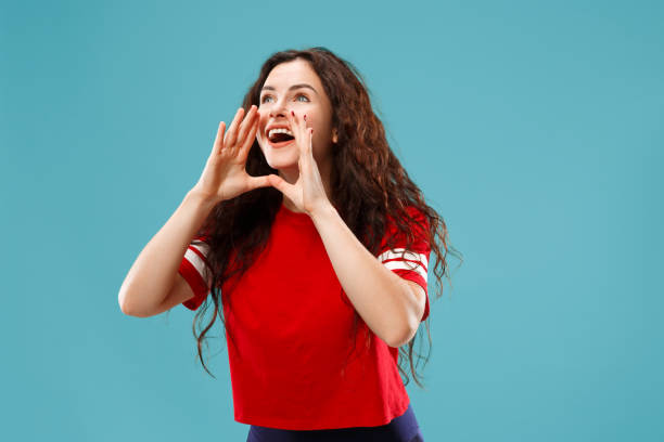 istock Isolated on pink young casual woman shouting at studio 1044904232