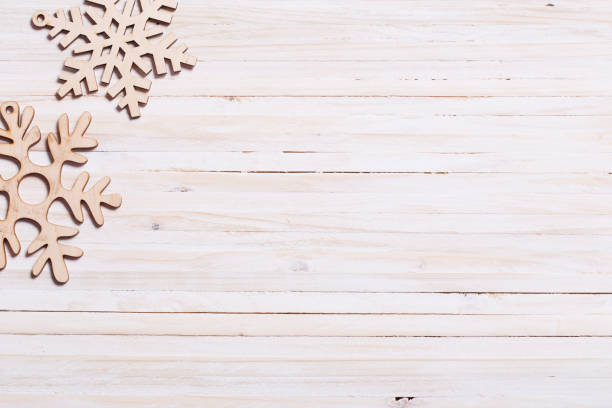 istock Snowflakes on wooden background 1044904928