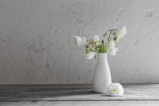 istock roses in vase on old background 1044904966