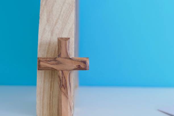 istock Wooden crucifix on wooden background 1044907376