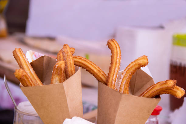 istock Delicious churros sticks deep fried in paper bag with powdered sugar 1044907386