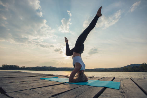 istock Yoga exercise by the river in sunset 1044907682