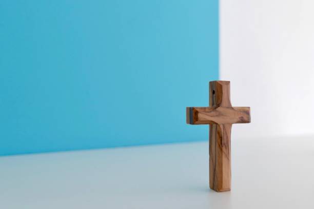 istock Wooden crucifix on blue white background 1044907834