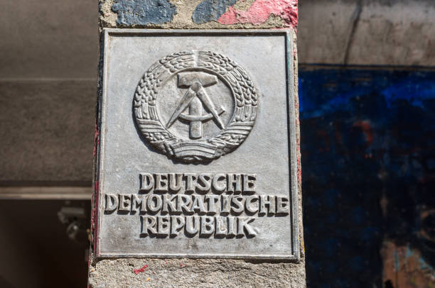 Berlin, Germany - May 28, 2017: The national emblem of the German Democratic Republic or DDR (East Germany) featuring a hammer and a compass, surrounded by a ring of rye on the border post near the Cold War Museum in Berlin.