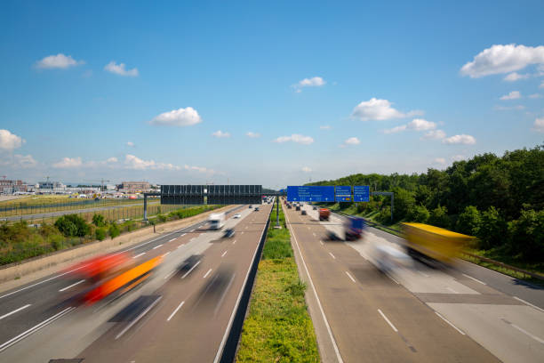 Autobahn highway with blurred trucks Frankfurt Germany Multilane Autobahn highway with blurred trucks and cars near Frankfurt Airport, Frankfurter Kreuz, Germany autobahn stock pictures, royalty-free photos & images