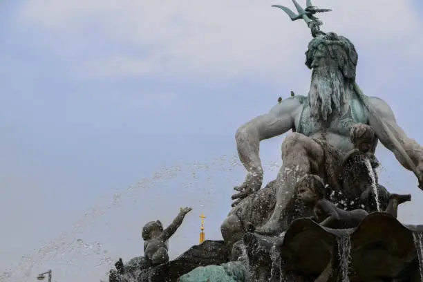 Part of the Neptune Fountain in center of  Berlin with the Greek god Poseidon (= Neptune for Romans), district Mitte, Germany, copy space