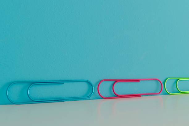 istock Colorful row of clips on blue background 1044912618