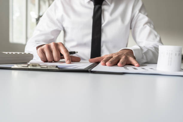 istock Low angle view of a businessman pointing to an analytical graph 1044912630