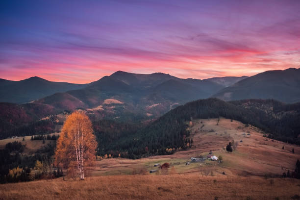 Beautiful pink and golden sunrise in autumn mountain landscape