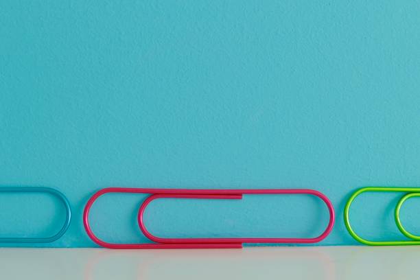 istock Colorful row of clips on blue background 1044912800