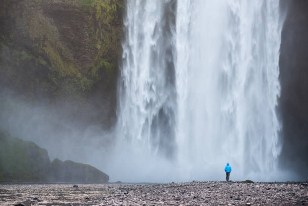 istock Tourist near Skogafoss waterfall, Iceland 1044916154