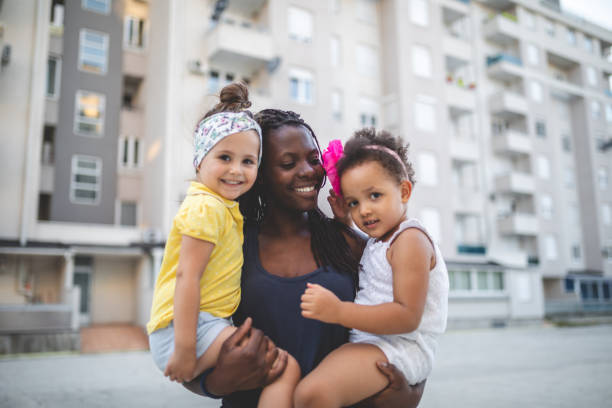 Lovely mixed race children being held by their mother