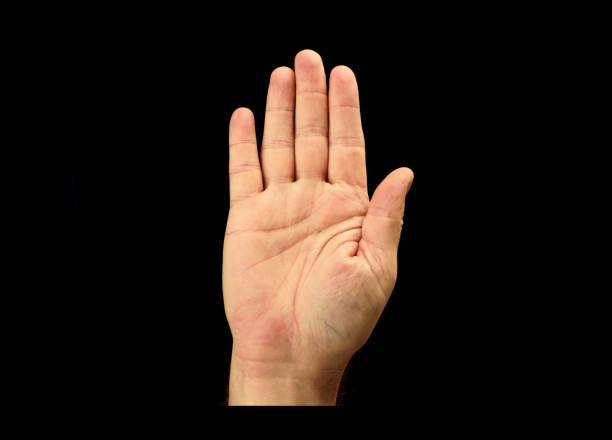 istock Male hand with an open palm isolated on black 1044933954