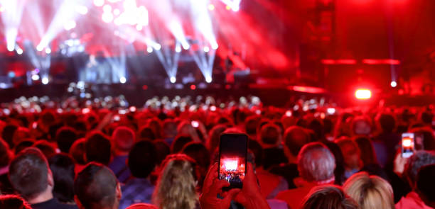 istock people with smart phone at live concert 1044935194