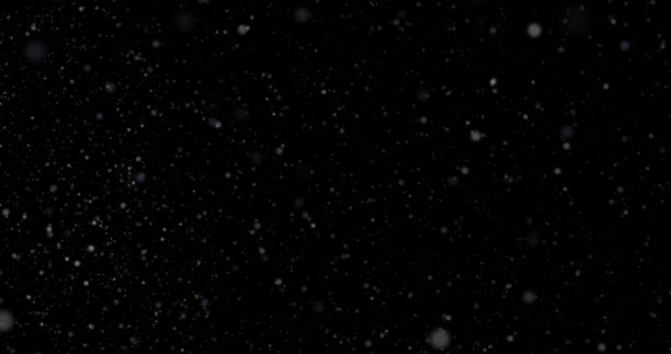 istock Natural white winter snowfall on a black background 1044935228
