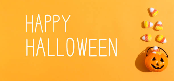 istock Happy Halloween message with pumpkin overhead view 1044935772