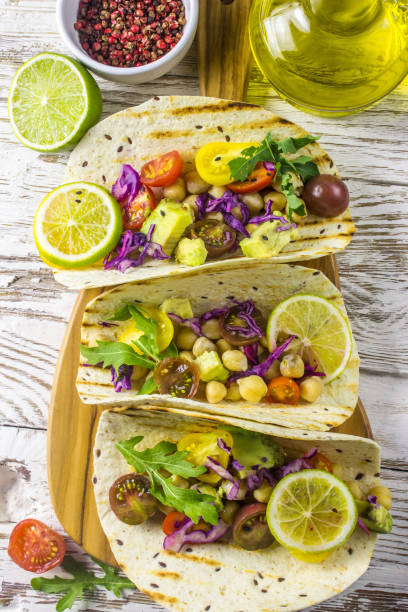 istock Healthy corn tortillas with chickpeas, tomatoes, avocado, fresh arugula, limes 1044938808