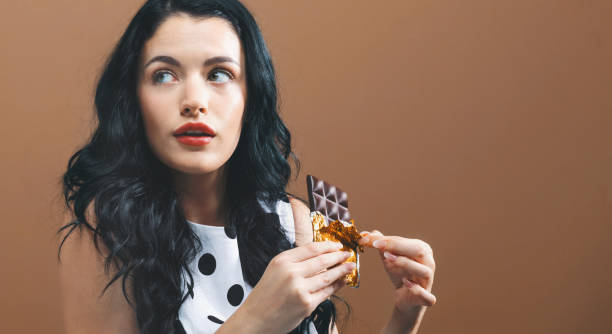 istock Young woman holding chocolate 1044939086