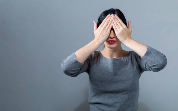 istock Woman covering her eyes with her hands 1044939170
